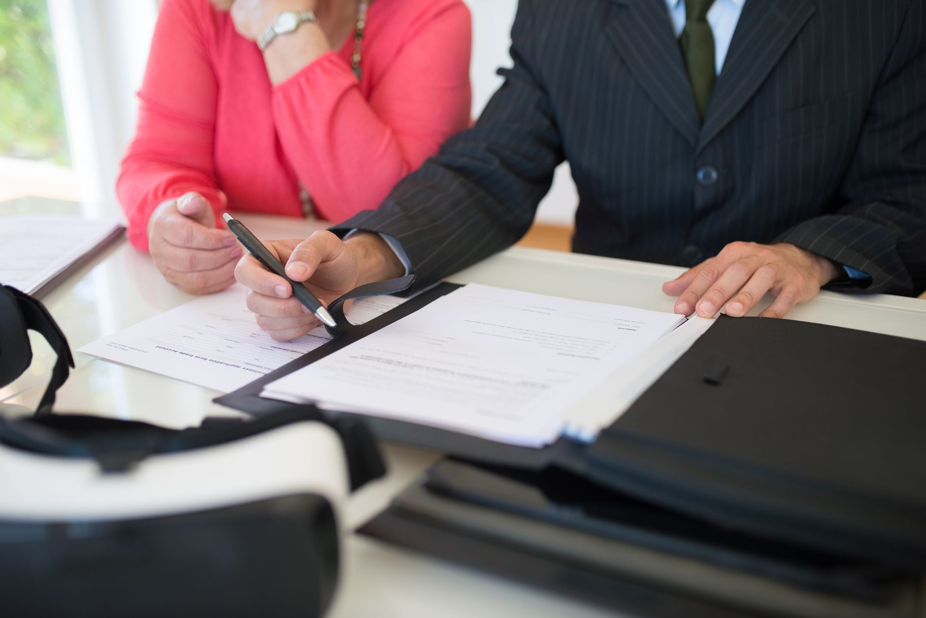 A trading desk beside a printed agreement, illustrating affiliate programmes for prop firms