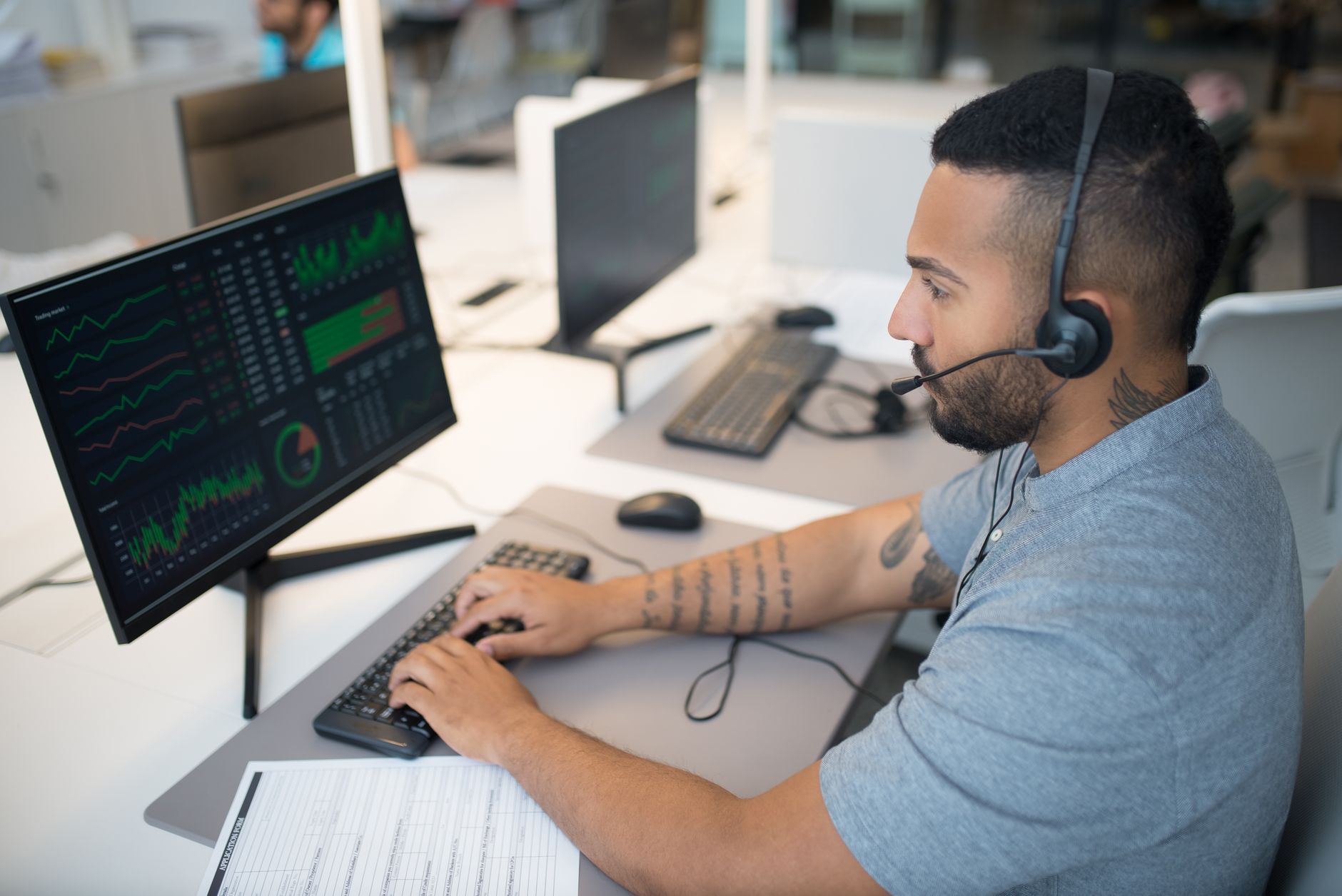 Trader using a headset at a computer while checking a prop firm Discord community