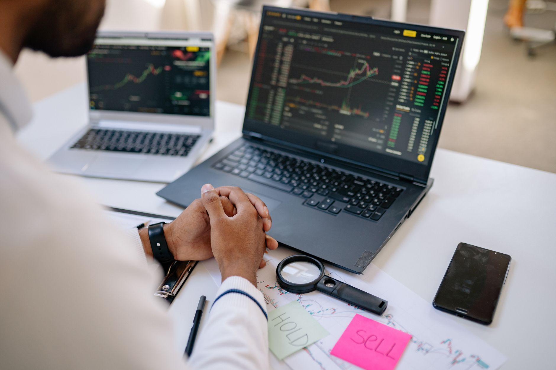 Laptop showing a trading dashboard beside notes about prop firm comparison pages