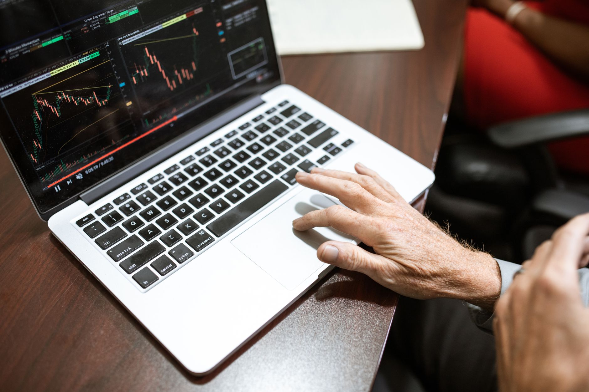 Trader reviewing charts on a laptop while researching prop firm search results